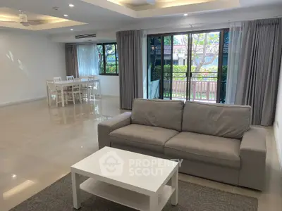 Spacious living room with modern furniture and garden view