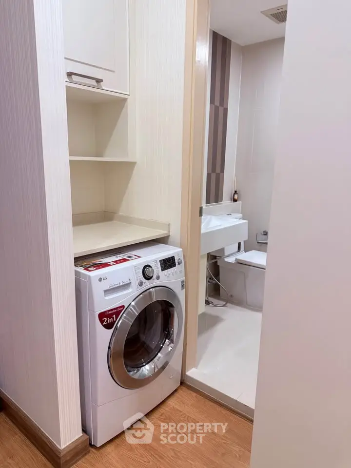 Compact bathroom with modern washing machine and sleek design