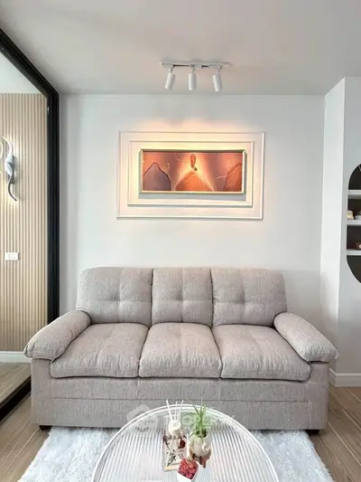 Modern living room with stylish sofa and elegant wall art, perfect for contemporary urban living.