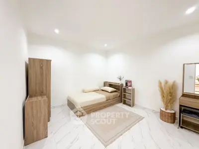 Minimalist bedroom with wooden furniture and neutral decor