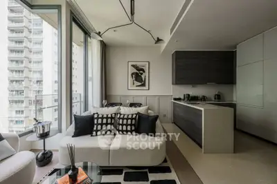 Modern living room with stylish decor and open kitchen layout in high-rise apartment