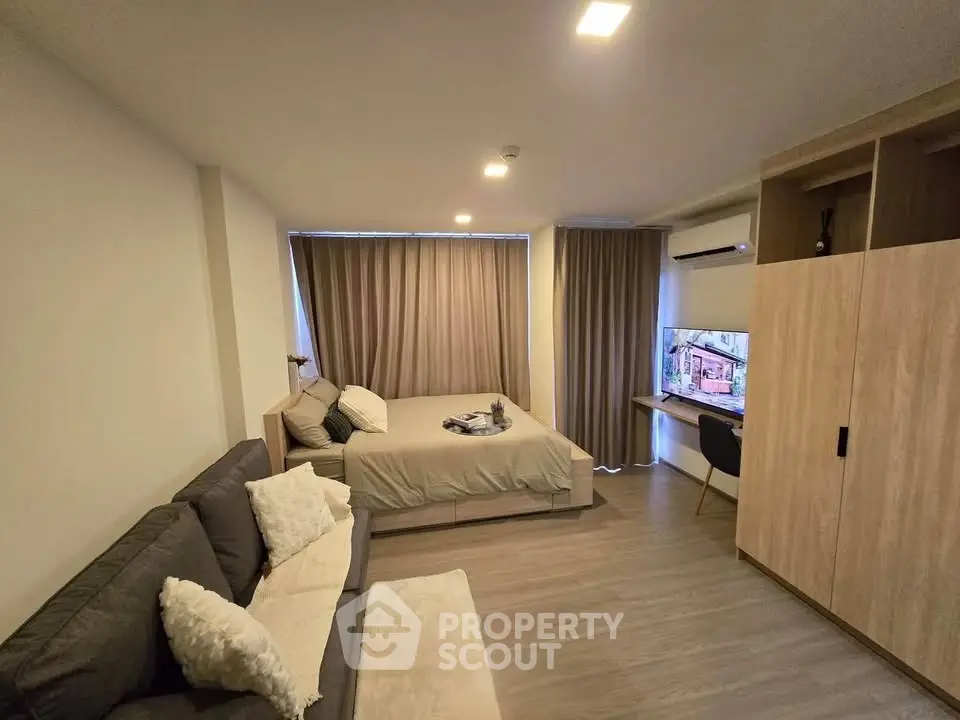 Modern studio apartment with cozy living area and stylish decor
