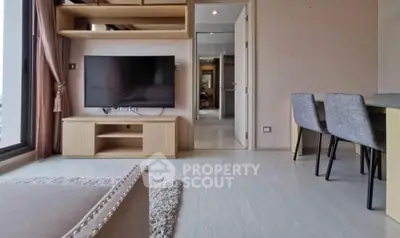Modern living room with sleek furniture and large TV, perfect for relaxation and entertainment.