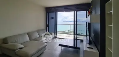 Stunning living room with ocean view and modern furnishings in a luxury apartment.