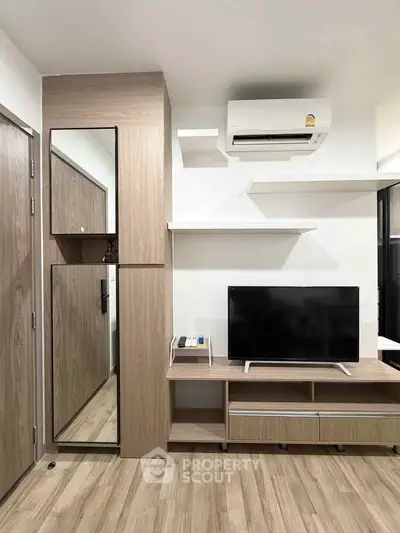 Modern living room with sleek wooden furniture and mounted air conditioner, perfect for cozy urban living.