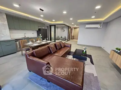 Spacious modern living room with open kitchen and elegant furnishings