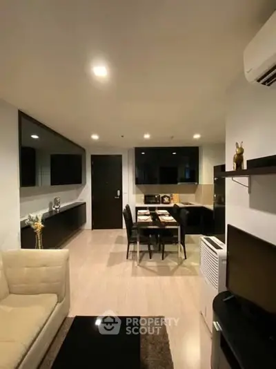 Modern living room with dining area, sleek furniture, and ambient lighting.