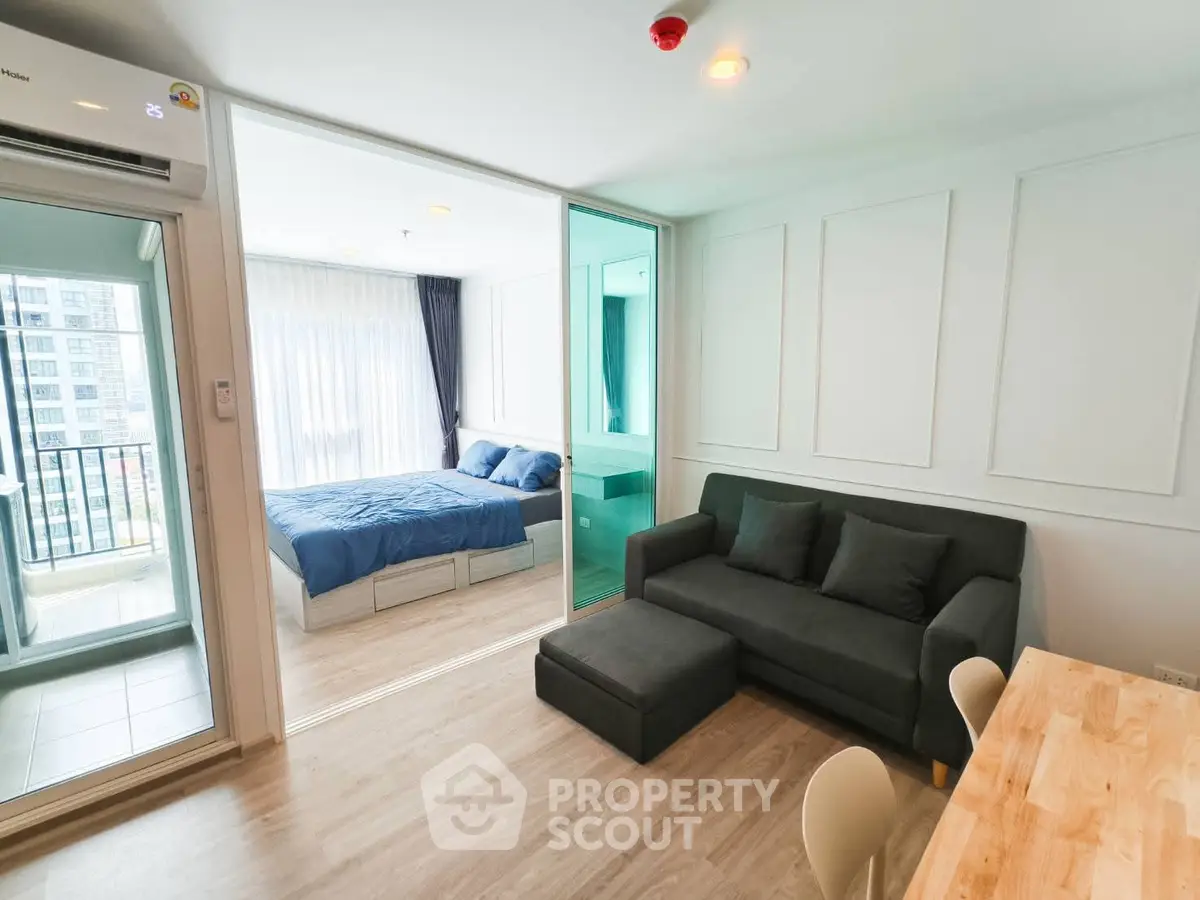 Modern studio apartment with cozy living area and bedroom, featuring a balcony and stylish decor.
