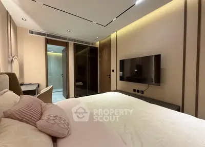 Luxurious modern bedroom with elegant decor and wall-mounted TV