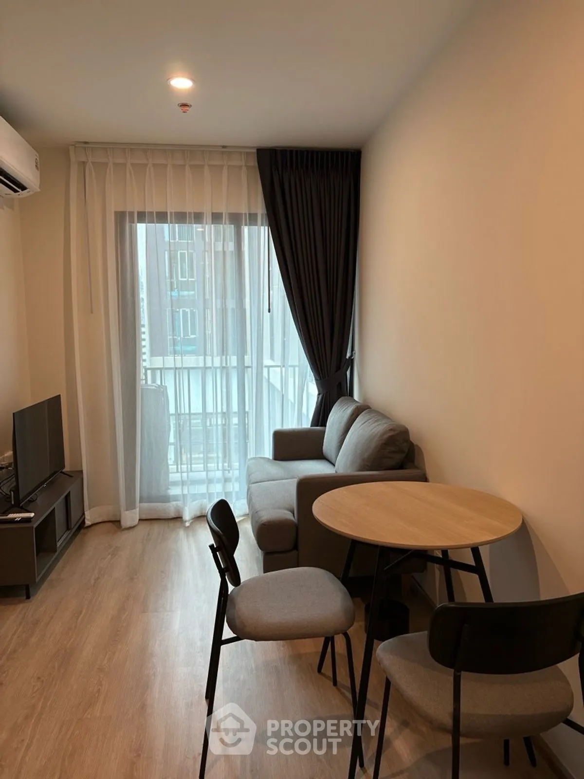 Cozy modern living room with natural light and stylish furniture, perfect for relaxation and entertainment.