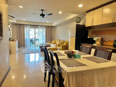 Spacious open-plan living and dining area with modern furnishings and natural light.