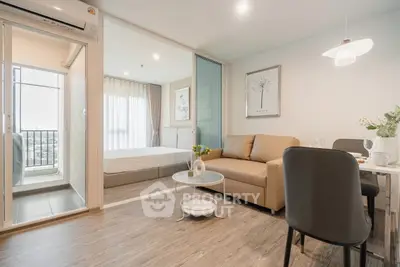 Modern open-plan living room with elegant decor and balcony view