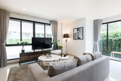 Spacious modern living room with large windows and stylish decor