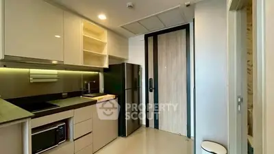 Modern kitchen with sleek cabinetry and stainless steel appliances in a compact layout.