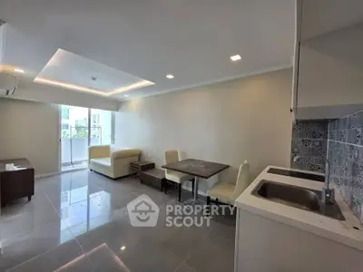 Modern open-plan living room with sleek kitchen and cozy dining area