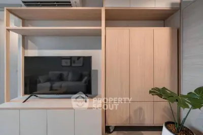 Modern living room with sleek TV unit and stylish wooden cabinetry