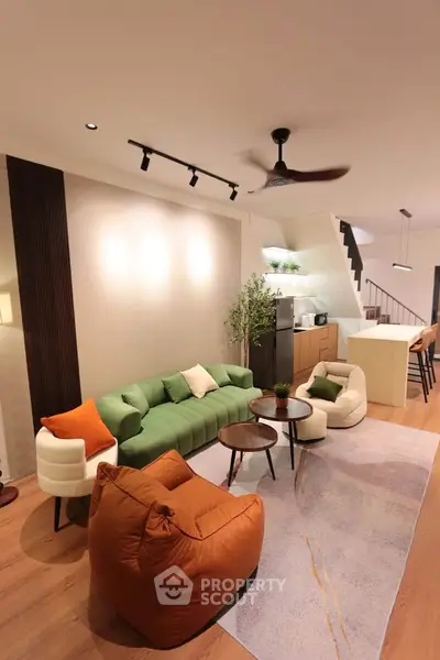 Modern living room with stylish furniture and open kitchen layout