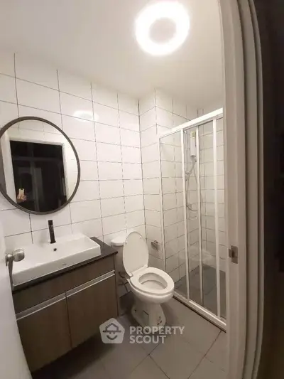 Modern bathroom with sleek fixtures and glass shower enclosure