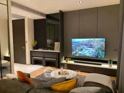 Modern living room with stylish decor and large TV, perfect for relaxation.