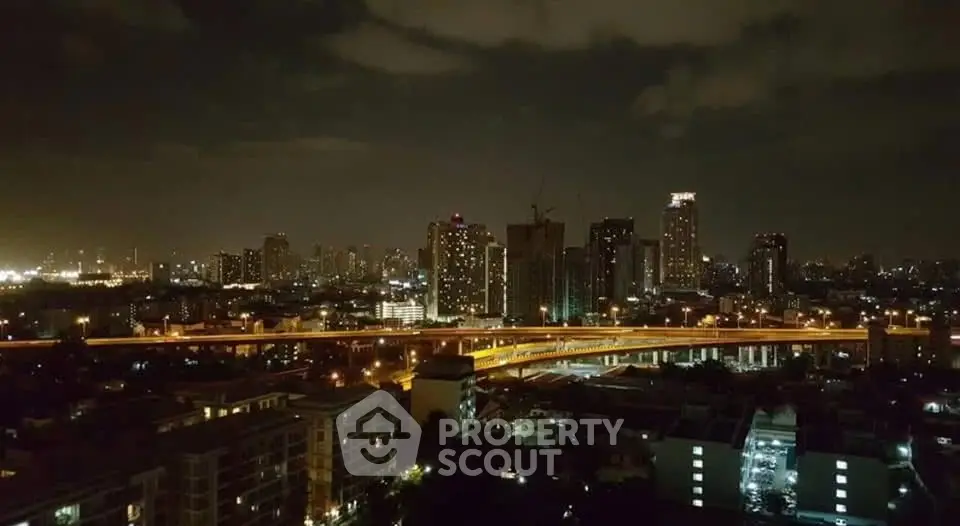 Stunning nighttime cityscape view with illuminated skyline and highway, perfect for urban living enthusiasts.