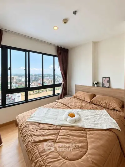 Cozy bedroom with large windows offering stunning city views and elegant decor.