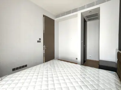 Modern minimalist bedroom with sleek design and neutral tones, featuring a comfortable bed and stylish decor.