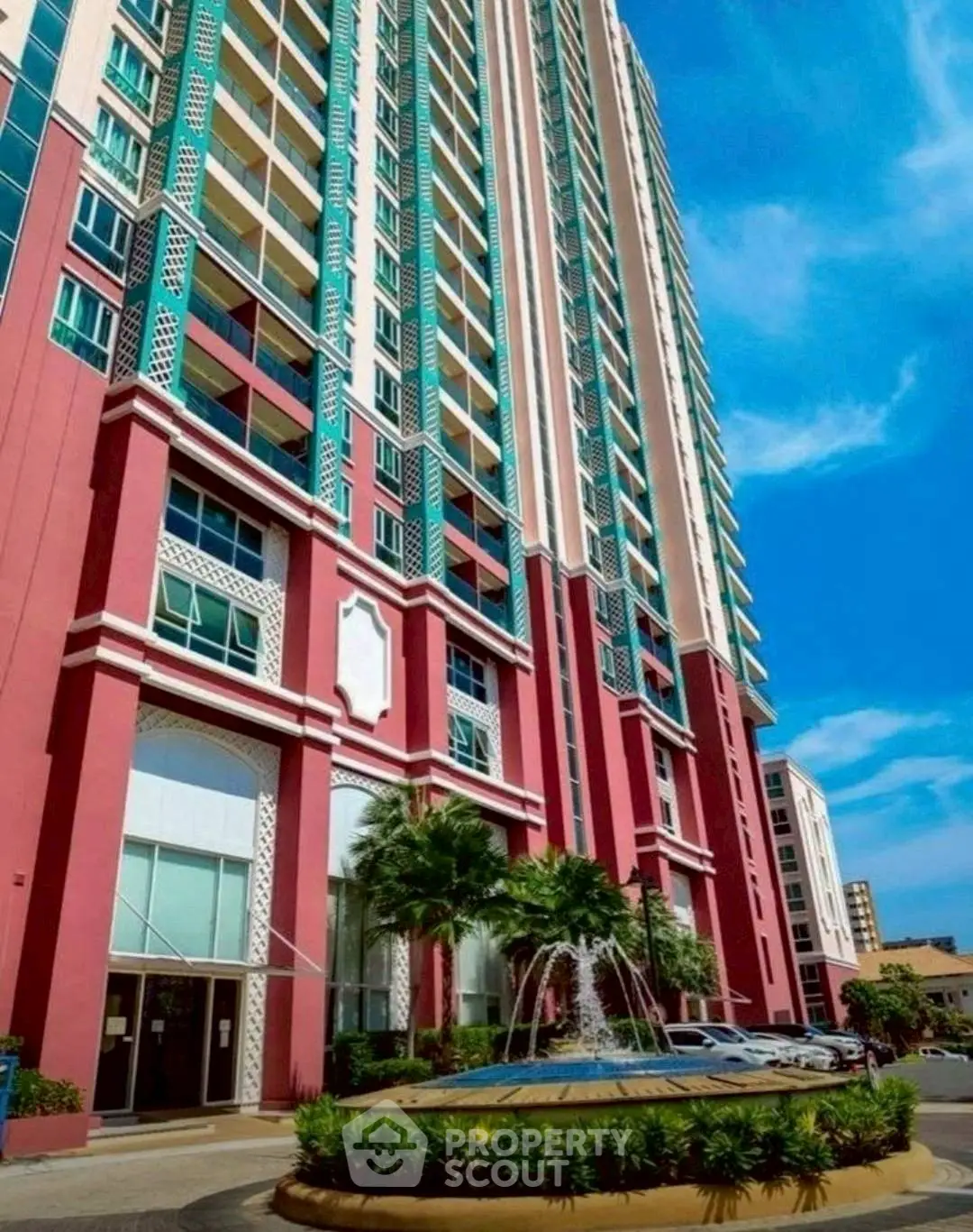 Stunning high-rise building with vibrant facade and elegant entrance fountain.