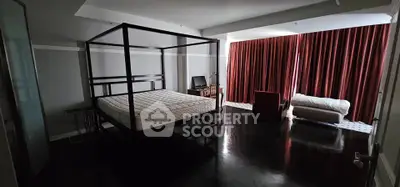 Spacious bedroom with elegant four-poster bed and modern decor