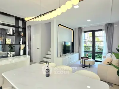 Modern living room with elegant decor, large windows, and stylish furniture, perfect for family gatherings.