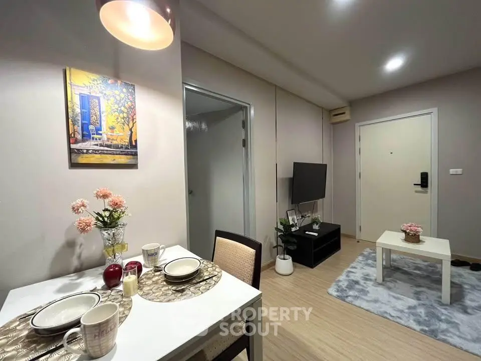 Modern living room with dining area, stylish decor, and cozy ambiance in a contemporary apartment.
