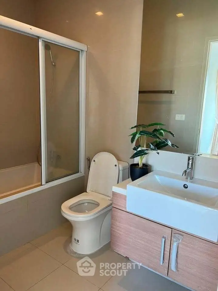 Modern bathroom with sleek fixtures and a bathtub in a contemporary apartment.