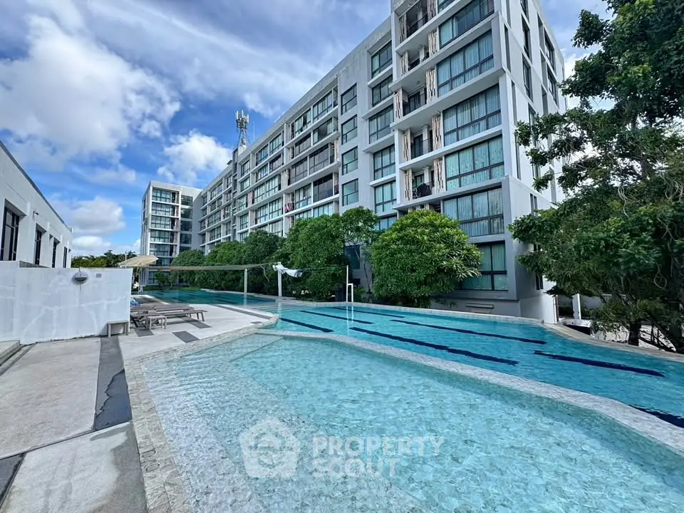 Luxurious modern apartment complex with stunning pool and lush greenery