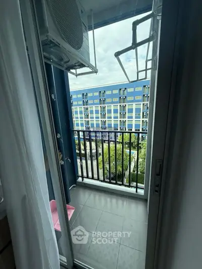 Modern apartment balcony with city view and air conditioning unit