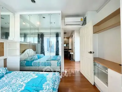Bright bedroom with mirrored wardrobe and modern air conditioning unit