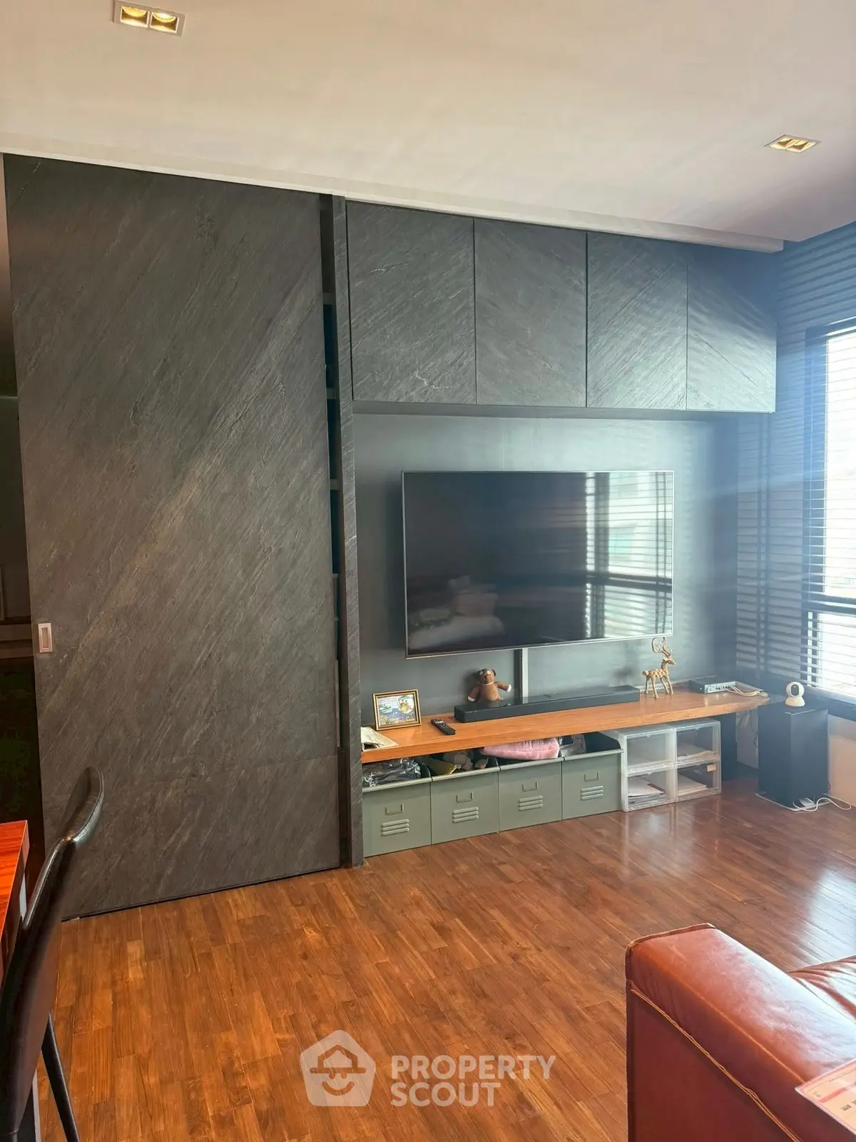 Modern living room with sleek TV setup and wooden flooring