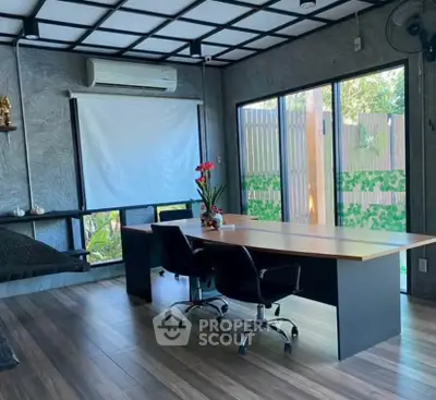 Modern home office with large windows and stylish decor