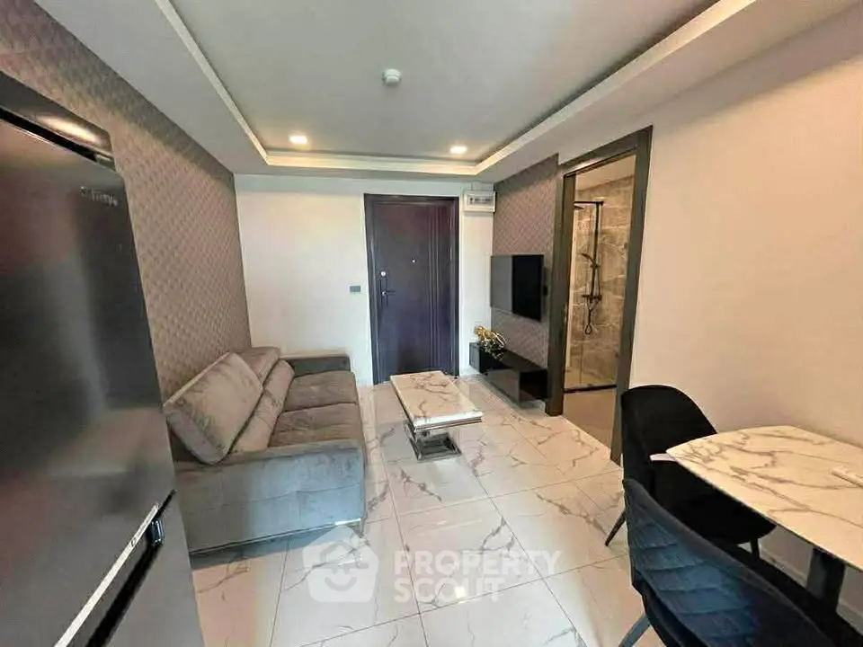 Modern living room with sleek design and marble flooring, featuring a cozy sofa and dining area.