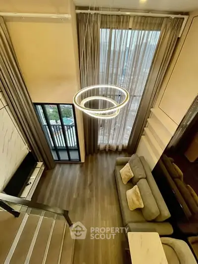 Luxurious modern living room with high ceilings and elegant lighting in a stylish apartment.