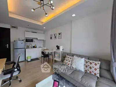 Modern living room with stylish decor and open kitchen layout in a cozy apartment.