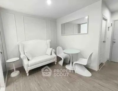 Modern minimalist living room with white furniture and wood flooring