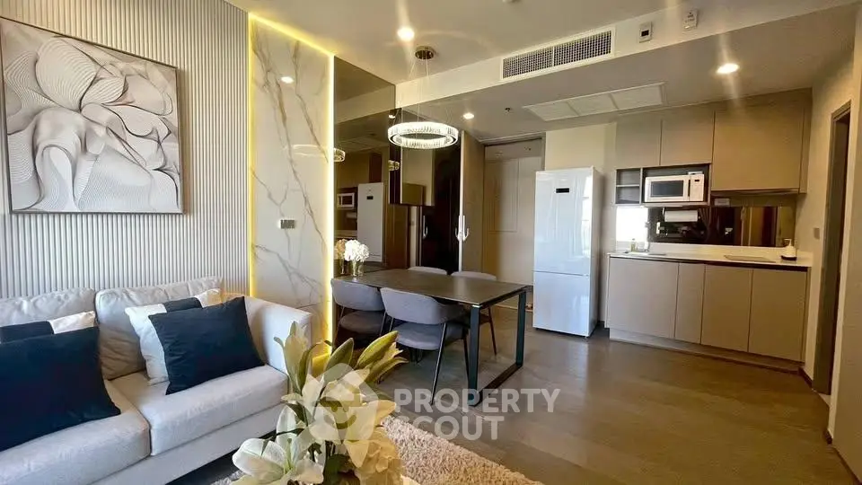 Modern open-plan living room and kitchen with elegant decor and stylish furniture