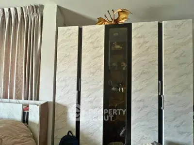 Stylish bedroom with modern wardrobe and elegant curtains