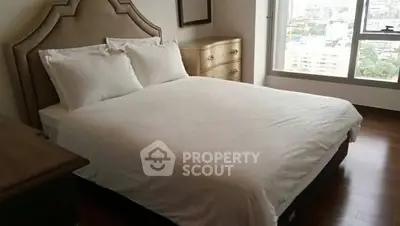 Spacious bedroom with elegant bed and city view window