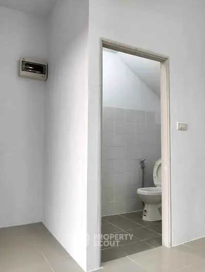 Minimalist bathroom with white tiles and modern toilet design
