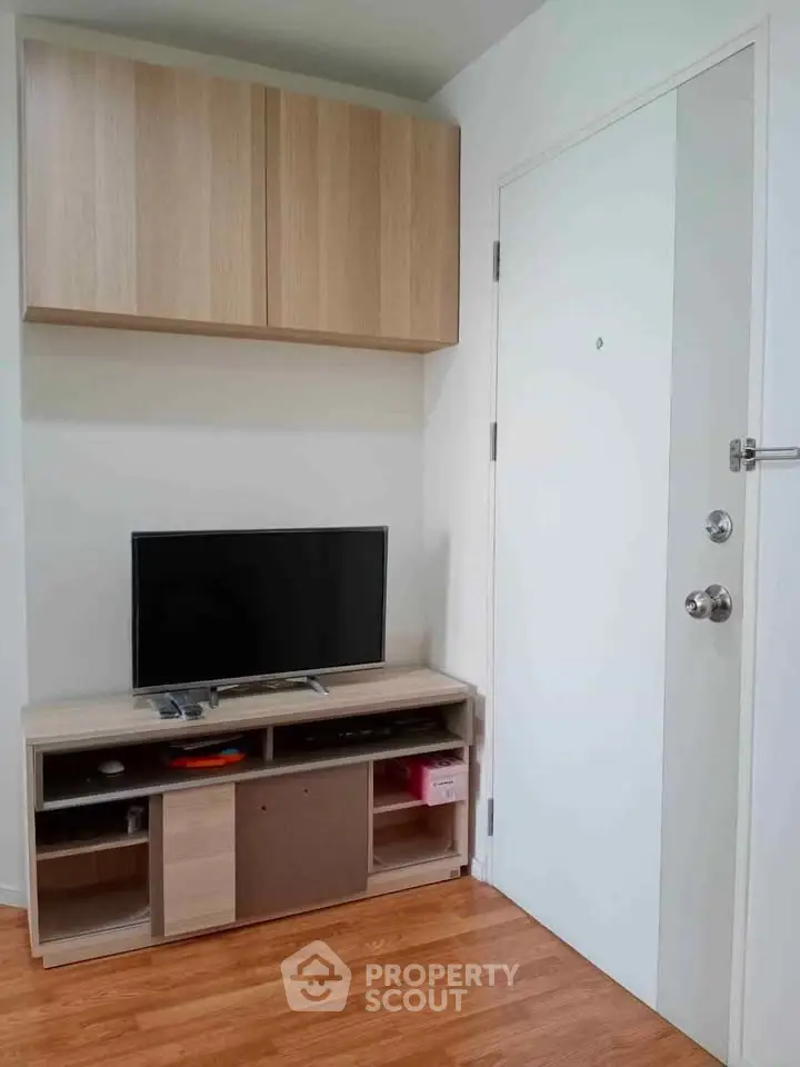 Modern living room with sleek TV stand and wooden flooring