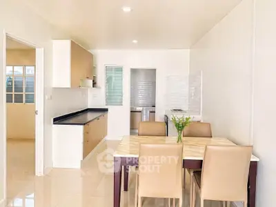 Modern dining area with open kitchen layout and elegant furnishings