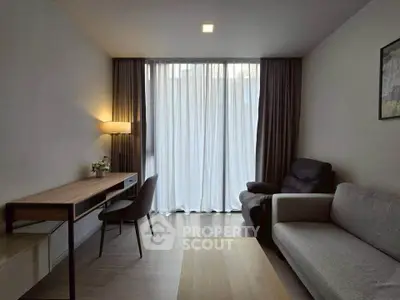 Modern living room with sleek furniture and large window, perfect for urban living.