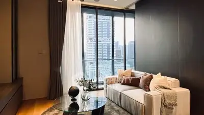 Luxurious living room with city view, modern decor, and floor-to-ceiling windows.