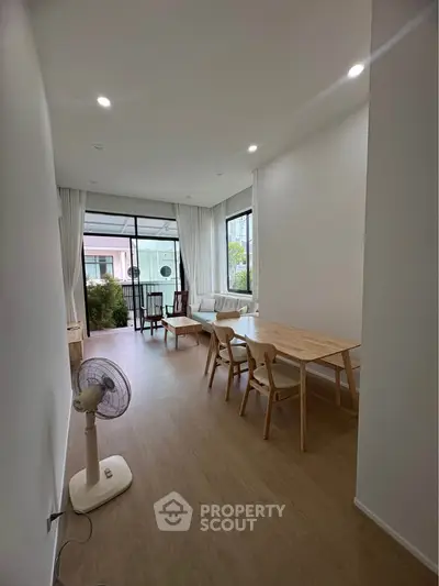 Spacious living room with modern furniture and large windows offering natural light.