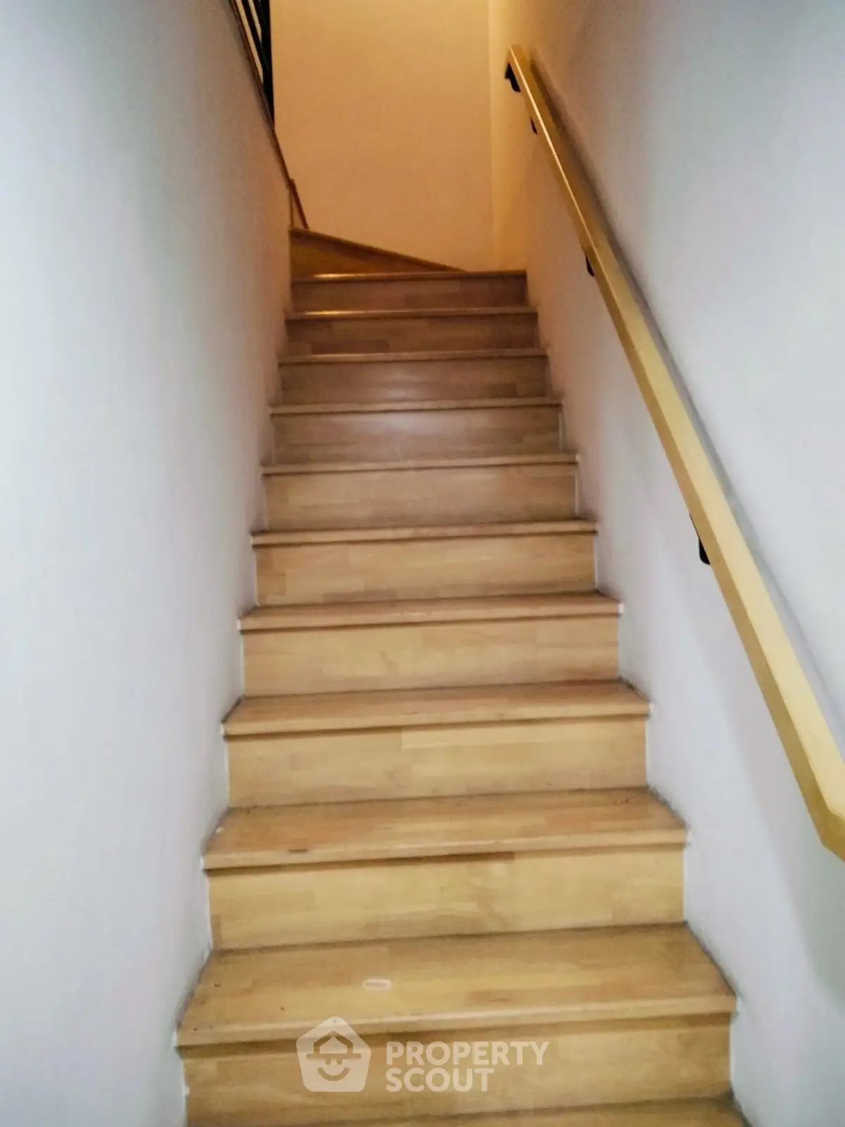 Elegant wooden staircase with sleek handrail in modern home
